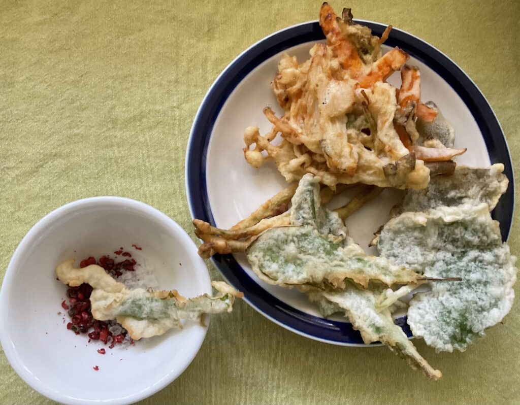 皿に盛った野草の天ぷらとかき揚げ
